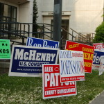 A bunch of signs outside of a polling place during the election